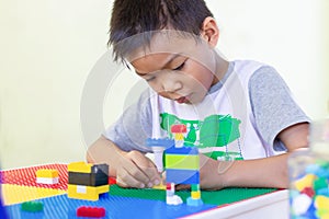 AsianÃ¢â¬â¹ childÃ¢â¬â¹ boyÃ¢â¬â¹ playingÃ¢â¬â¹ withÃ¢â¬â¹ theÃ¢â¬â¹ plasticÃ¢â¬â¹ blockÃ¢â¬â¹ toys.Ã¢â¬â¹ photo